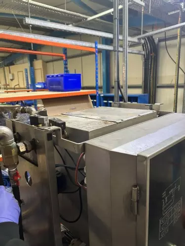 Original Nilfisk SC Delta multi-pump system in a Birmingham food factory prior to upgrade, showing the existing smaller water tank setup that struggled to keep up with high-demand clean-down operations.
